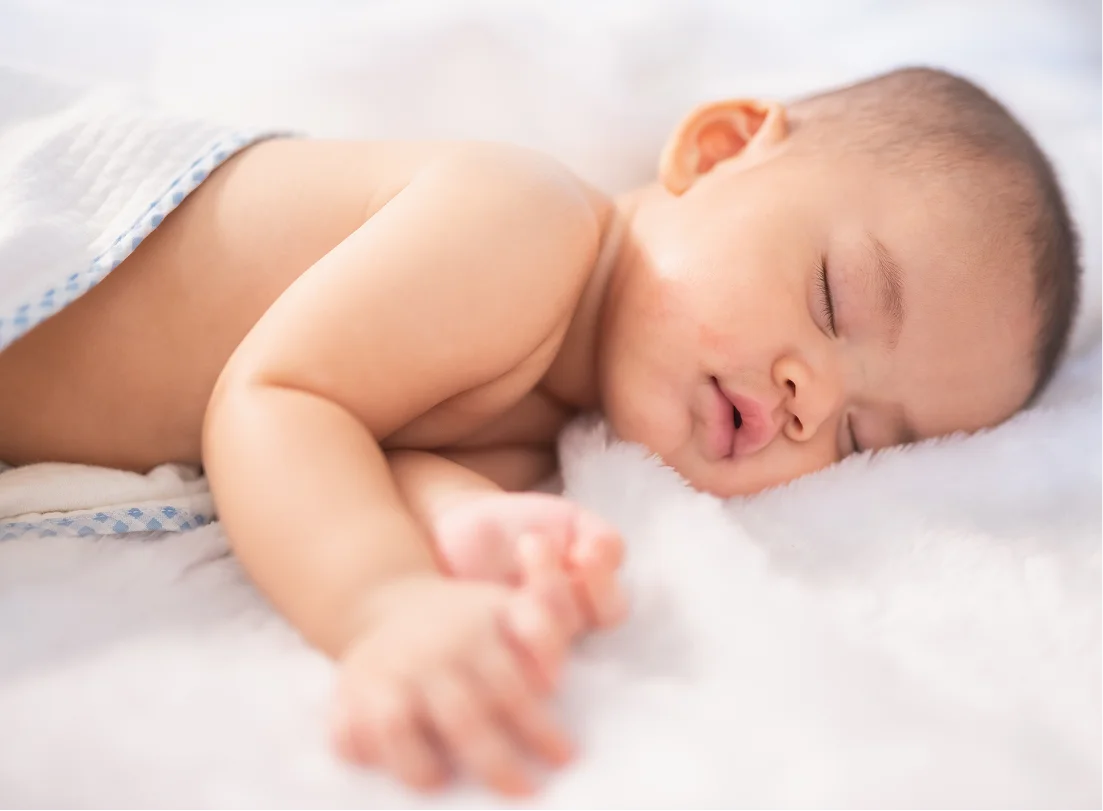 Mom holding baby in arms at home